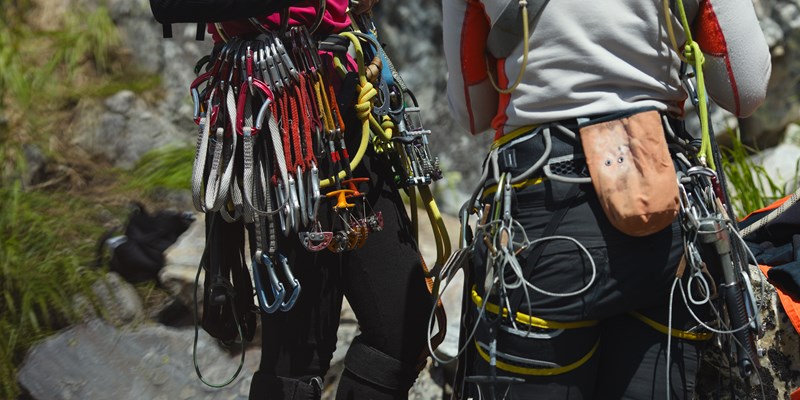 Tools, gear and equipment on the belt of a rock climbers close-up.